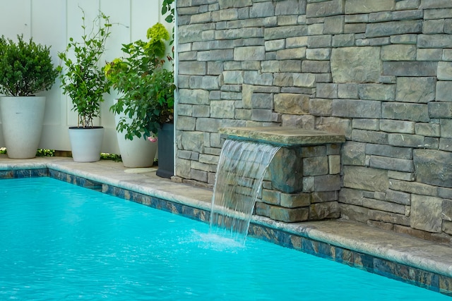 view of pool with pool water feature