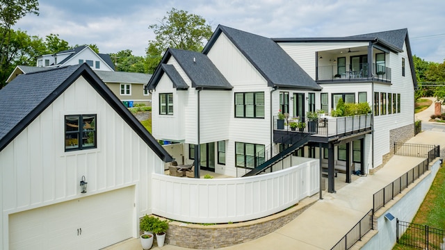 rear view of house with a garage and a balcony