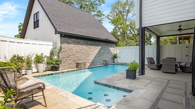 view of swimming pool with ceiling fan and a patio area