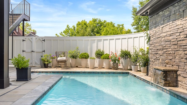 view of pool with pool water feature