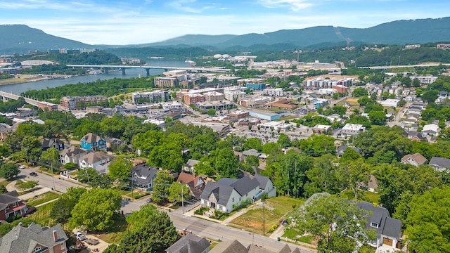 drone / aerial view featuring a water and mountain view