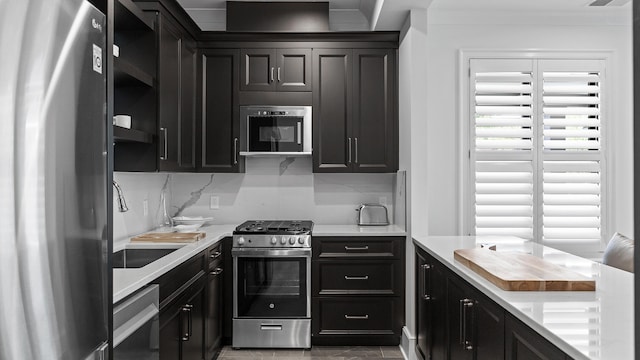 kitchen featuring sink, backsplash, and appliances with stainless steel finishes