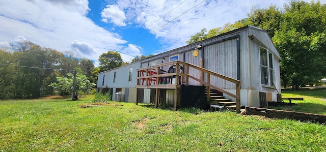 rear view of property with a lawn