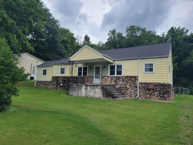 back of property featuring a lawn