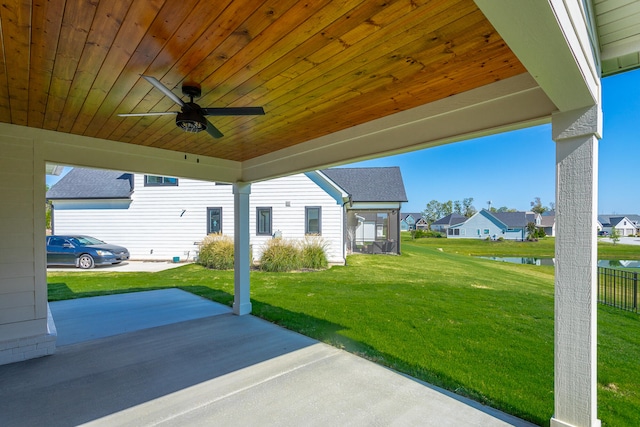 view of patio / terrace featuring a water view and ceiling fan