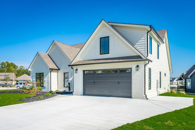 view of front facade with a garage and a front lawn