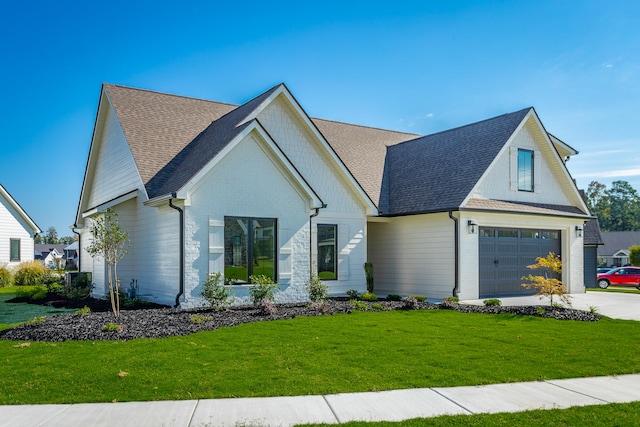 modern farmhouse with a front lawn and a garage