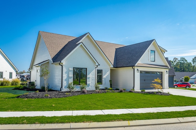 modern farmhouse style home with a front yard and a garage