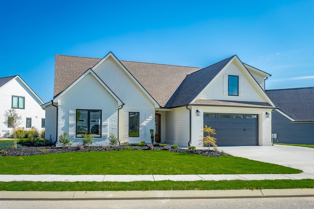 modern farmhouse style home featuring a garage and a front lawn