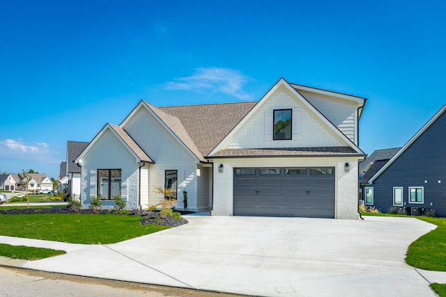 modern farmhouse style home featuring a front yard and a garage