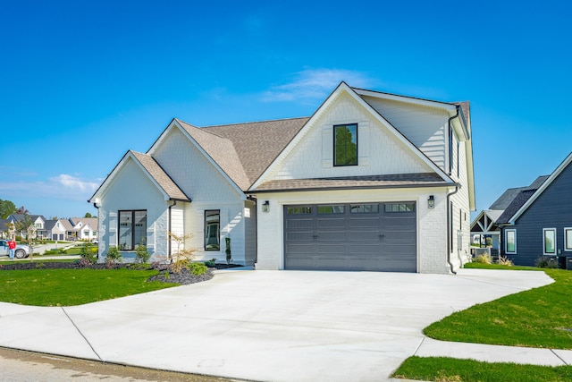 modern farmhouse style home with a garage and a front yard