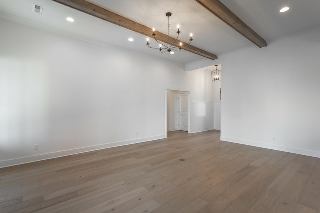 empty room featuring a notable chandelier, beamed ceiling, hardwood / wood-style flooring, and crown molding