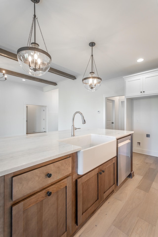 kitchen featuring sink, white cabinets, an inviting chandelier, decorative light fixtures, and stainless steel dishwasher