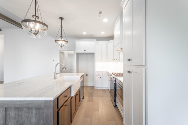 kitchen featuring light hardwood / wood-style floors, white cabinetry, and stainless steel stove