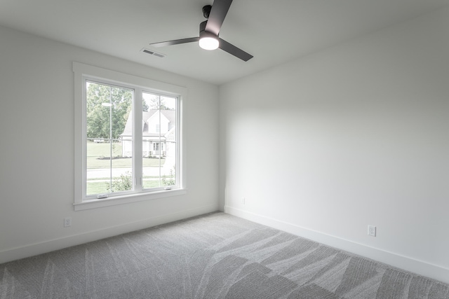 empty room with carpet floors, ceiling fan, and plenty of natural light