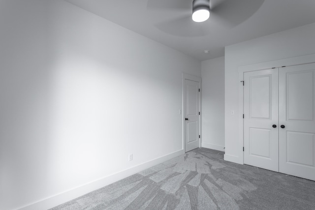 unfurnished bedroom with carpet floors, ceiling fan, and a closet