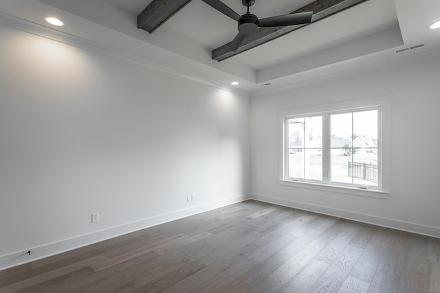 empty room with wood-type flooring, ceiling fan, and beamed ceiling