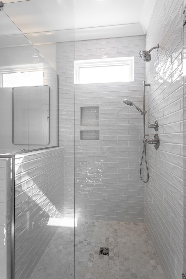 bathroom featuring a tile shower