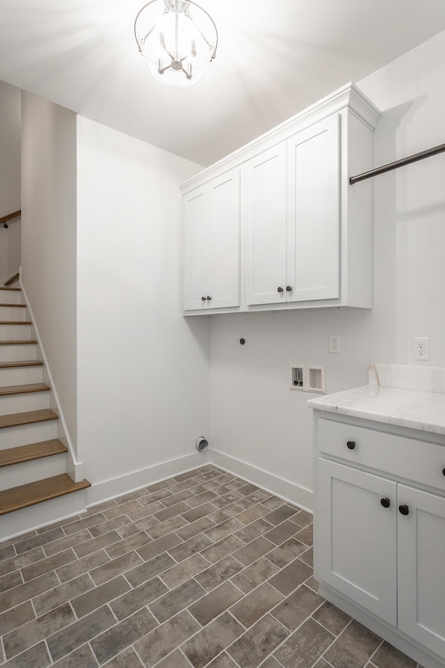 clothes washing area with washer hookup, hookup for an electric dryer, cabinets, dark hardwood / wood-style floors, and a notable chandelier