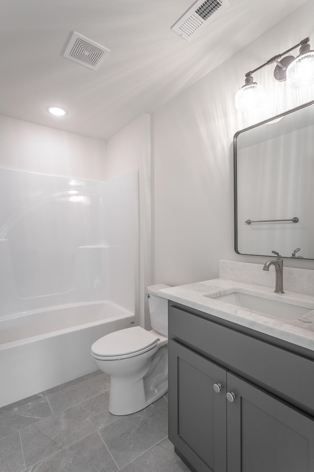 full bathroom featuring washtub / shower combination, vanity, and toilet