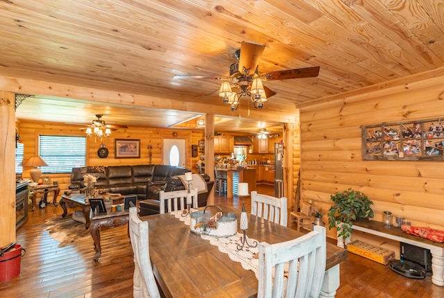 dining area with wood ceiling, ceiling fan, rustic walls, and wood-type flooring