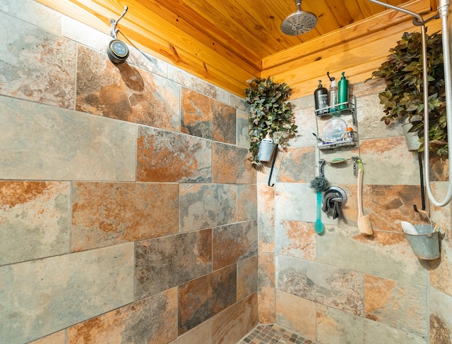 details with wood ceiling and a tile shower