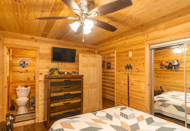 bedroom featuring wooden walls, ensuite bathroom, hardwood / wood-style floors, wood ceiling, and ceiling fan