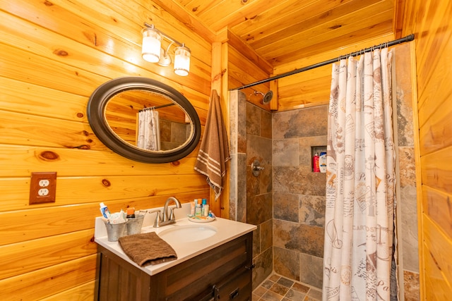 bathroom with wood walls, walk in shower, wooden ceiling, and vanity