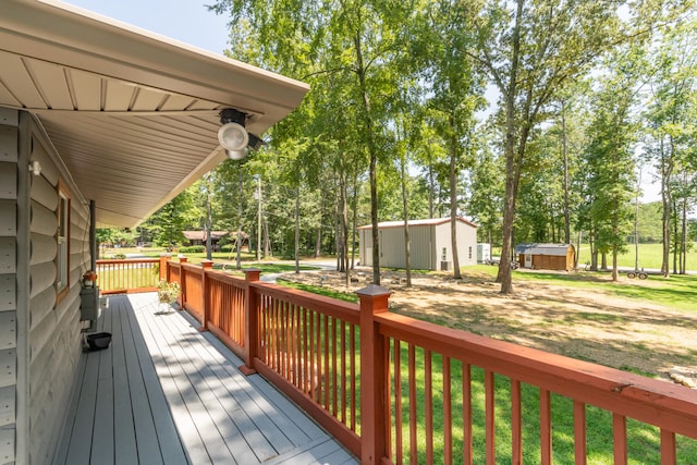 wooden deck featuring a yard and a storage shed