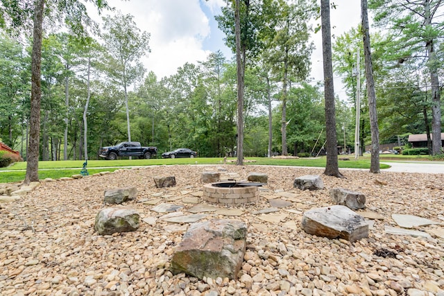 view of yard with a fire pit