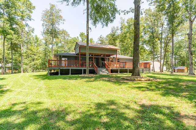 rear view of house featuring a yard and a deck