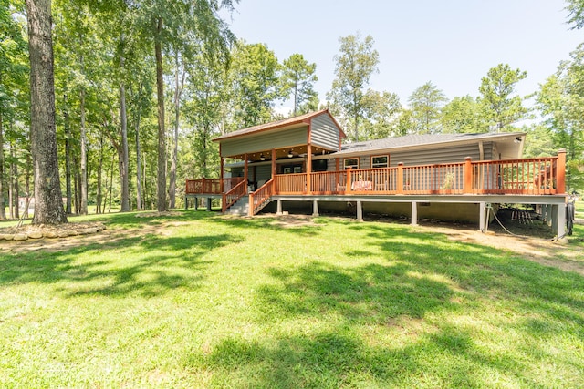 back of house featuring a wooden deck and a lawn