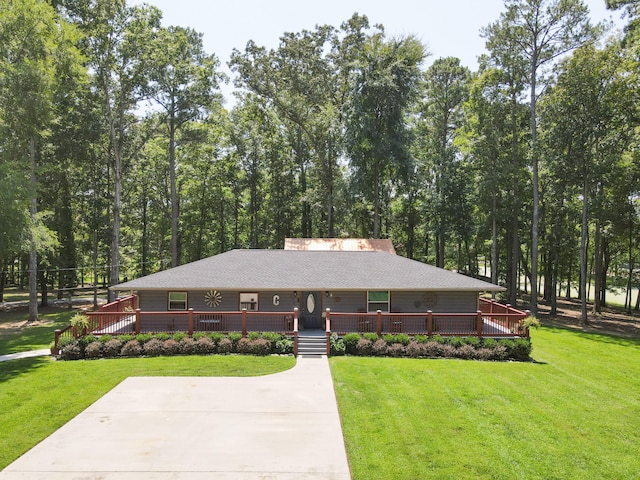 ranch-style home featuring a front lawn and a deck