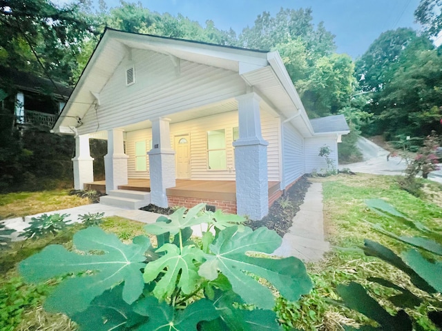 back of property with a porch