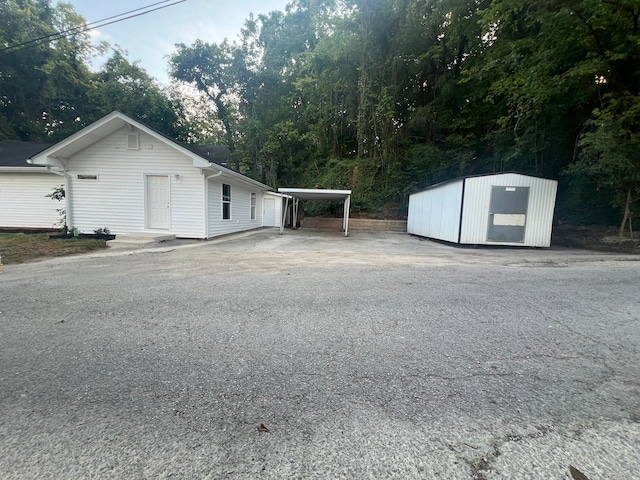 view of home's exterior featuring a carport and a storage unit