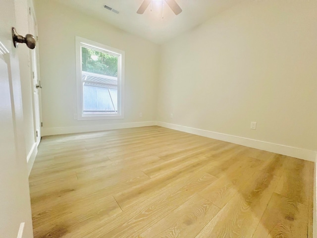 spare room with light wood-type flooring and ceiling fan