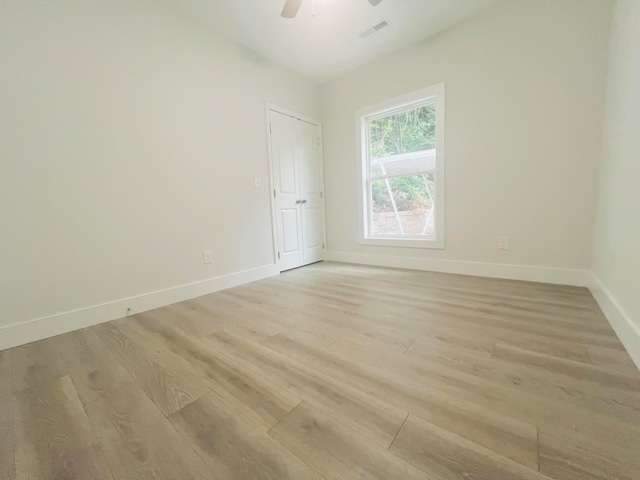 unfurnished room with ceiling fan and light hardwood / wood-style floors