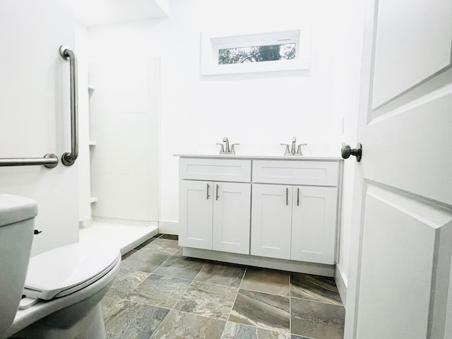 bathroom featuring toilet and vanity