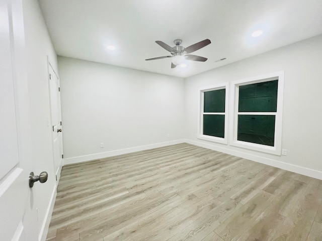 empty room featuring ceiling fan and light hardwood / wood-style floors