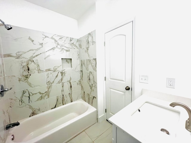 bathroom with tiled shower / bath combo and vanity