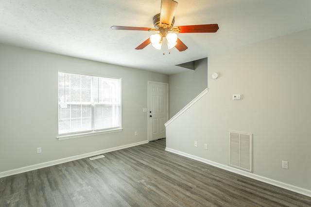 spare room with ceiling fan, dark hardwood / wood-style flooring, and a textured ceiling