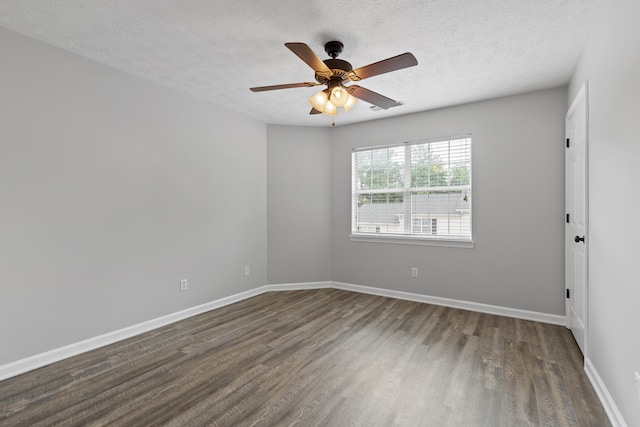 spare room featuring ceiling fan, dark hardwood / wood-style flooring, and a textured ceiling