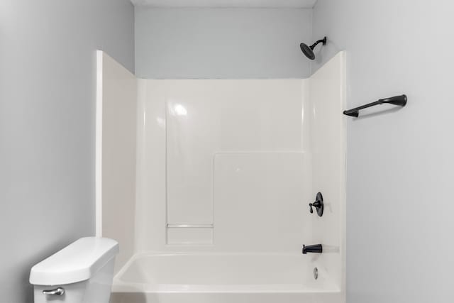 bathroom with toilet and bathtub / shower combination