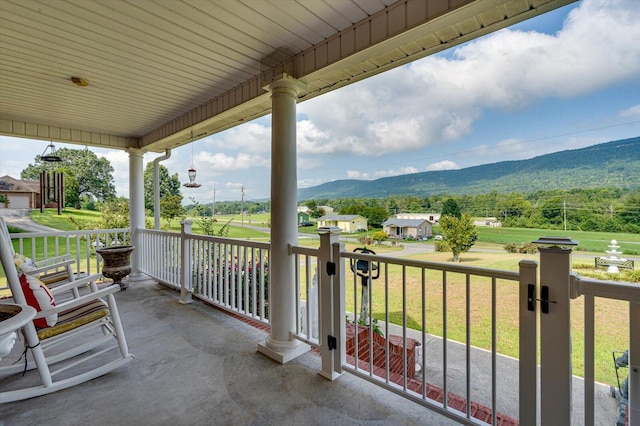 balcony featuring a porch and a mountain view