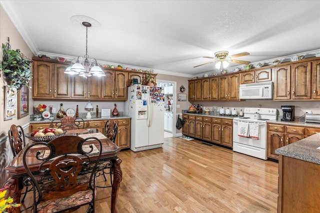 kitchen featuring light wood-type flooring, pendant lighting, ceiling fan with notable chandelier, ornamental molding, and white appliances