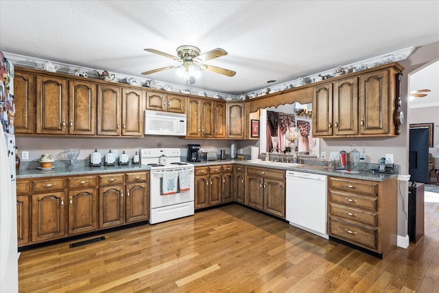 kitchen with hardwood / wood-style floors, white appliances, a textured ceiling, sink, and ceiling fan