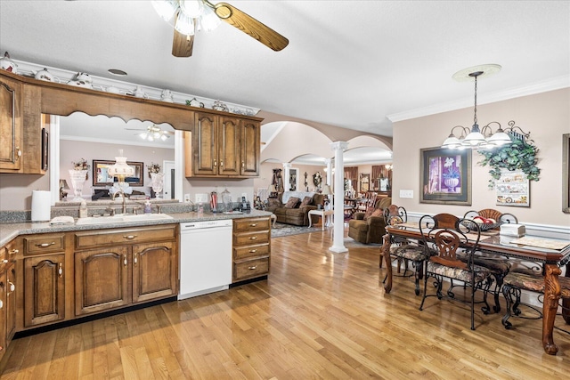 kitchen with ceiling fan with notable chandelier, light hardwood / wood-style flooring, white dishwasher, hanging light fixtures, and ornate columns