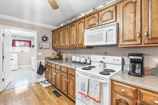 kitchen with crown molding, white appliances, light hardwood / wood-style flooring, ceiling fan, and washer / dryer