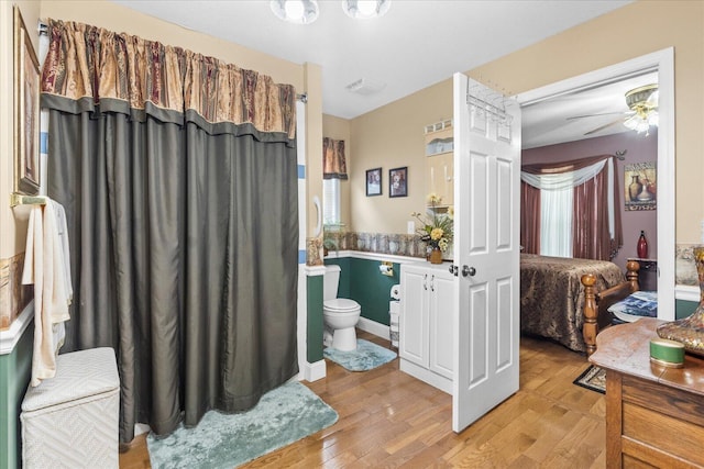 bathroom featuring toilet, ceiling fan, and hardwood / wood-style flooring