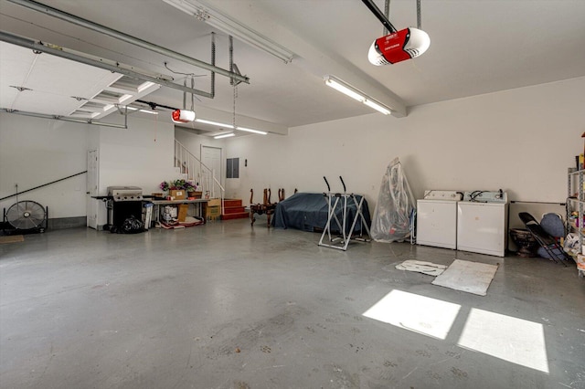 garage with electric panel, washing machine and dryer, and a garage door opener